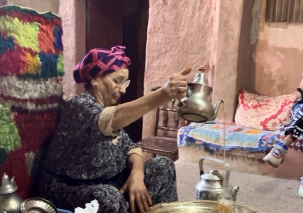 Traveler exploring a tea ceremony in a local's home, representing cultural immersion through food and connection.