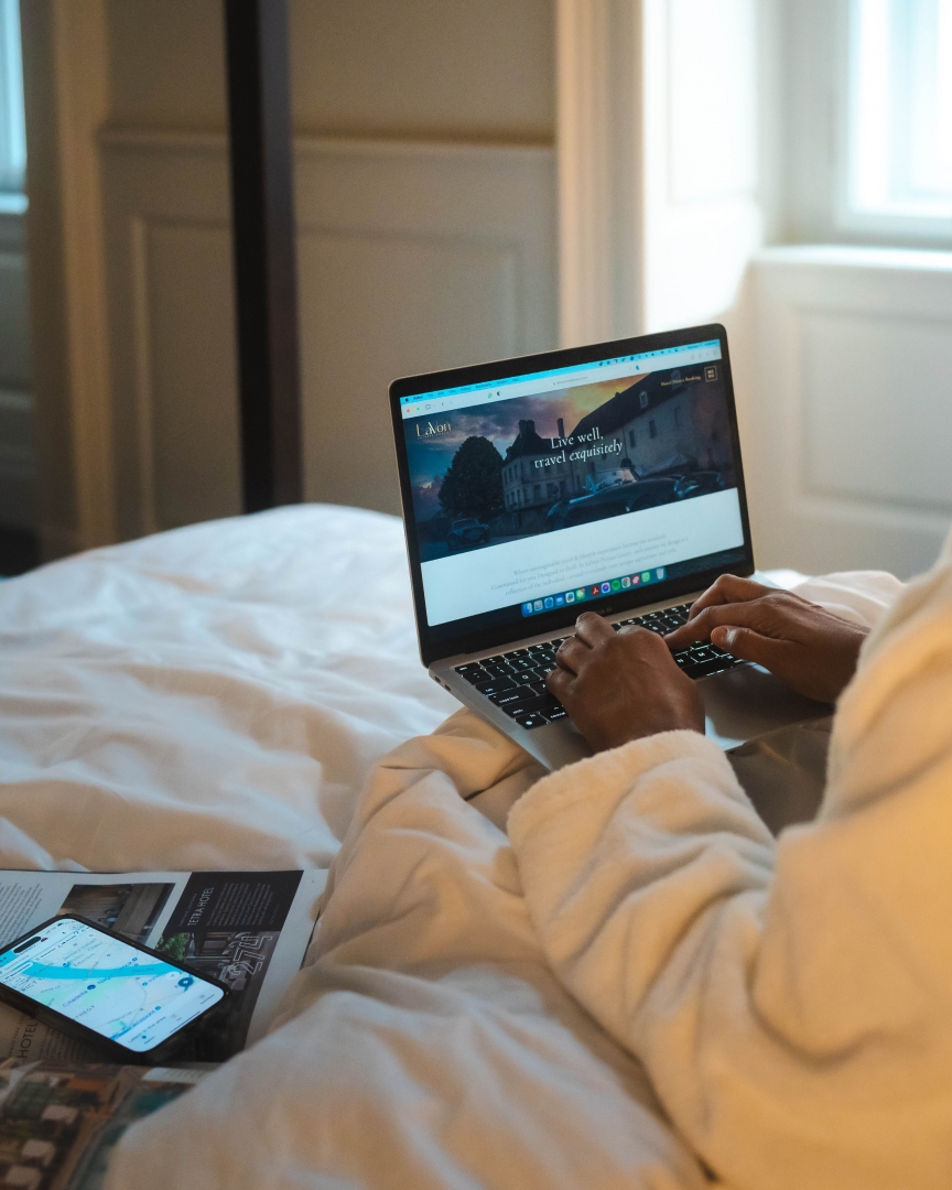 Woman planning a 2026-2027 international trip with laptop and travel itinerary notes
